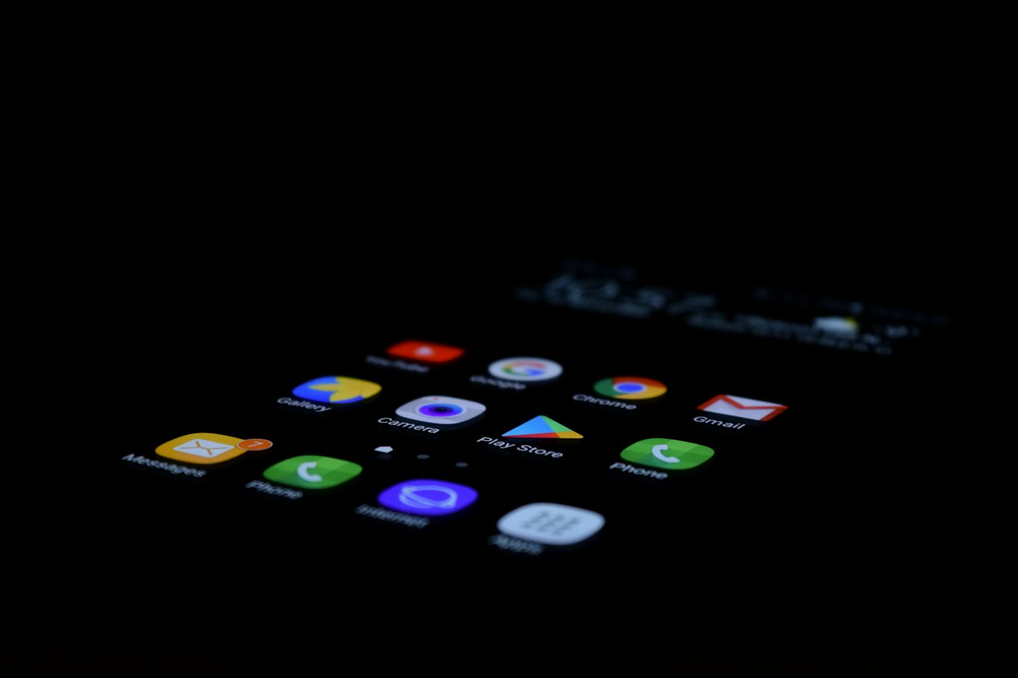 Smartphone screen displaying colorful app icons in the dark.